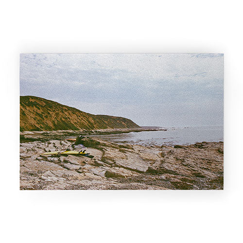 DENY Designs rocky beachside Welcome Mat